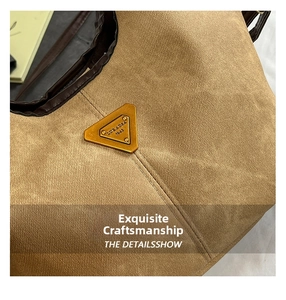 Close-up of triangle metal logo and premium stitching on khaki canvas bucket bag