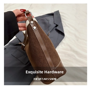 Detail showing brown corduroy texture and silver hardware on a crossbody bucket bag