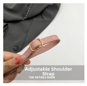 Close-up of adjustable pink shoulder strap with gold metal buckle on a shoulder bag