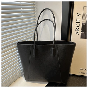 Close-up of black pebble leather tote bag with FASHION & BAGS LEATHER embossing