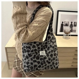 Close-up of leopard print faux fur texture and branded square label on the shoulder bag