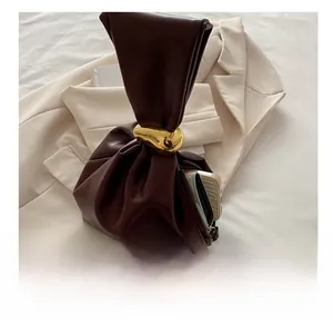 Interior view of brown pleated bucket bag showing capacity for phone and wallet