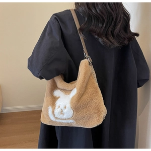 Detailed view of plush rabbit tote bag with brown faux fur and elegant chain strap