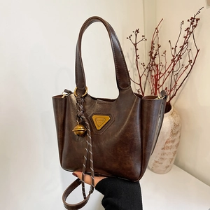 Retro brown PU leather tote bag with gold metal logo and bell charm for women