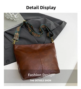 Detail of dark brown retro bucket bag featuring vintage patterned wide strap and gold buckle