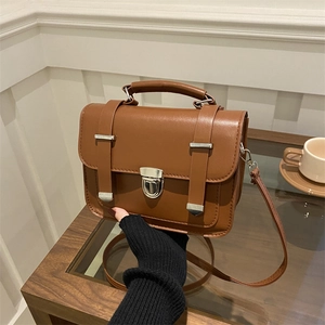 Vintage brown leather crossbody square bag with top handle and metal buckle closure