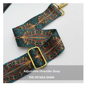 Detail showing adjustable ethnic style wide strap with bronze metal hooks for shoulder bag