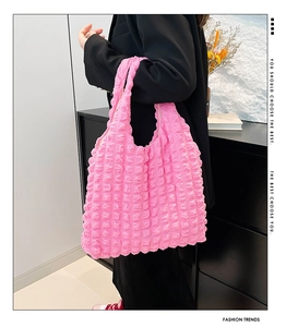Detail of hot pink popcorn texture fabric on a large capacity stylish tote bag