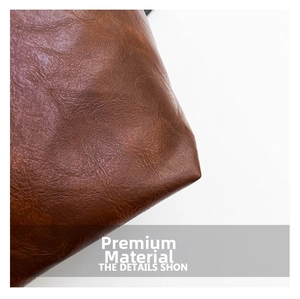 Close-up of brown litchi pattern leather showing material texture and flexibility