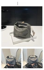 Detailed macro view of dark grey crossbody bag with golden metal hardware and strap