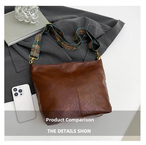 Detail view of brown vintage bucket bag with bohemian print wide shoulder strap
