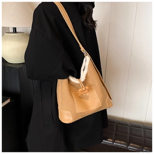 Detail of khaki corduroy bucket bag with faux fur trim and wood toggle closure