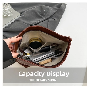 Interior view of brown leather bucket bag showing large capacity for tablet and cosmetics