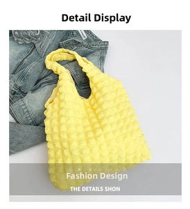 Close-up of bright yellow puff tote bag with unique 3D bubble texture and soft fabric