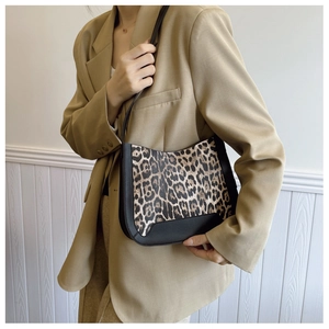 Detailed view of leopard print suede and black leather patchwork shoulder bag