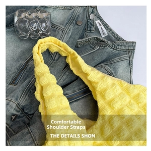 Detail of yellow puffy tote bag featuring textured bubble fabric and wide shoulder strap