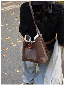 Detail of corduroy tote bag with faux shearling trim and vintage toggle closure