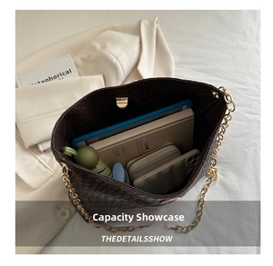 Interior view showing large capacity of woven tote bag with tablet and daily essentials