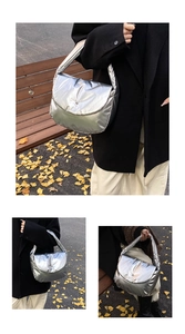 Detailed views of metallic silver puffer shoulder bag with soft quilted texture