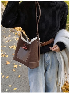 Detail of retro corduroy shoulder bag with fleece trim and vintage horn buckle
