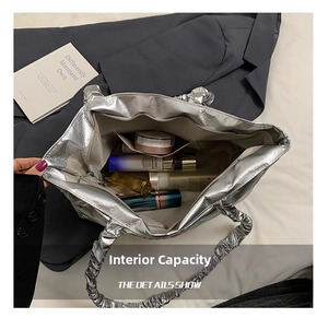 Macro view showing spacious interior storage and ruffles of silver metallic tote bag
