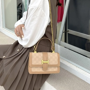 Chic beige and brown checkered crossbody bag with gold H buckle on a fashion model