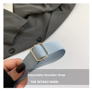 Close-up of high-density light blue woven adjustable shoulder strap with silver buckle