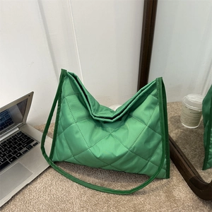 Green quilted nylon tote bag with large square stitching for stylish women commuting