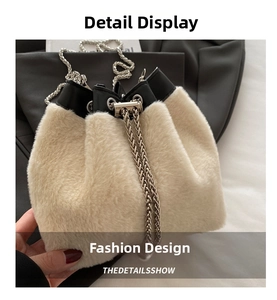 Detail view of cream plush bucket bag featuring black PU trim and silver chain strap