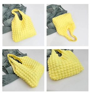 Detail view of yellow bubble-textured tote bag showing the soft quilted 3D fabric pattern