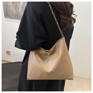 Detail of khaki woven texture handbag with golden metal twist lock and chain strap
