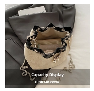 Detail showing the inner capacity of this plush bucket bag with chain and pearls