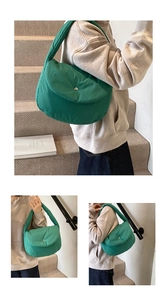 Detail view of green quilted puffer shoulder bag with puffy texture and metal button closure
