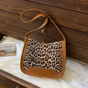 Leopard print faux suede bucket bag with brown leather trim and slim shoulder strap