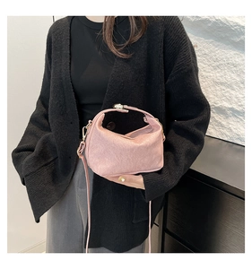 Detail of pink hobo shoulder bag with textured finish and elegant gold-tone hardware