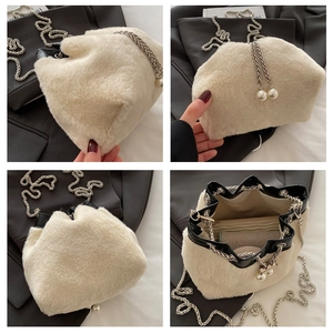 Detail of cream plush bucket bag with pearl pendants and silver chain strap details