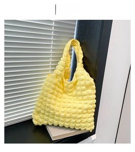 Detailed view of yellow popcorn fabric texture on a large minimalist tote bag