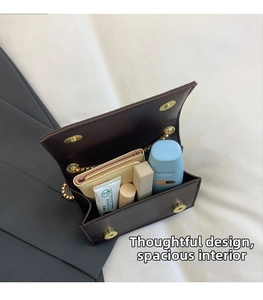Top view of dark brown crossbody bag interior showing spacious storage for cosmetics