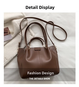 Detail of vintage brown PU leather tote bag showing gold hardware and adjustable strap