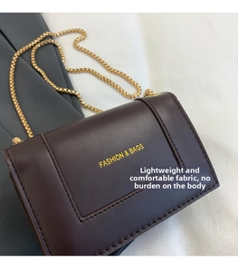 Detail of matte dark brown PU leather square bag with gold FASHION & BAGS lettering