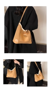 Detail of corduroy shoulder bag with fleece trim and vintage horn button closure