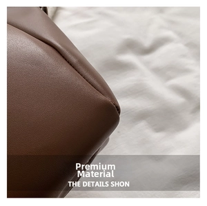 Macro detail of high-quality dark brown litchi pattern leather with visible grain texture
