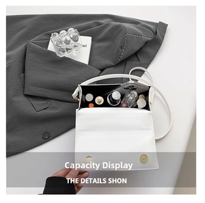Interior view showing the large capacity for phone and makeup in a white shoulder bag