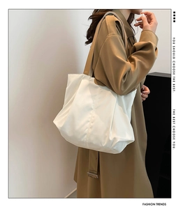 Detail of white large capacity tote bag with natural pleat design for minimalist styling