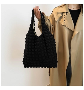 Detail of black popcorn texture tote bag showing its unique puffed fabric and large capacity