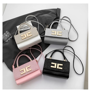 Top view of four elegant mini handbags in gold, silver, pink and black with sequin flaps