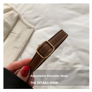 Detailed macro view of adjustable PU leather shoulder strap with gold buckle on tote bag
