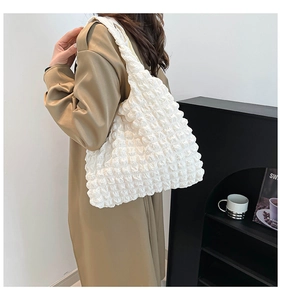 Detail of white puffy pleated texture on a large capacity sweet floral tote bag