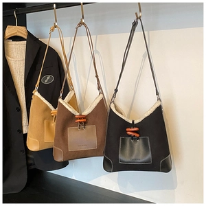 Detailed view of plush patchwork tote bags with wooden horn buckles in three colors