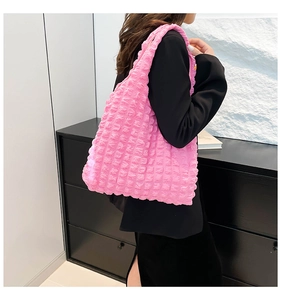 Pink bubble textured pleated tote bag shown on model highlighting large capacity and style
